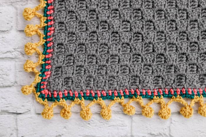 How to crochet a pom pom edging or bobble stitch border on a modern crochet afghan or blanket.