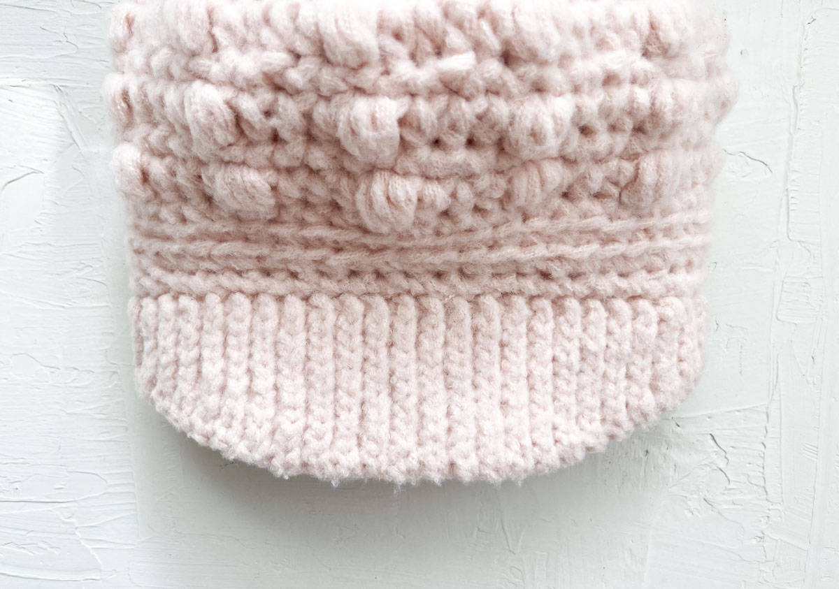 Top view of a ribbed brim attached to crocheted hat.
