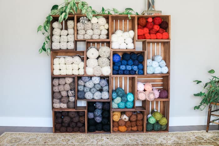 This yarn storage changed my life! Use wooden crates to build an easy shelf to organize your yarn, craft room or books. Perfect for knitters, crocheters and weavers!