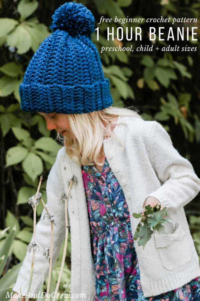 A child picking up leaves outside wearing a crochet ribbed beanie.