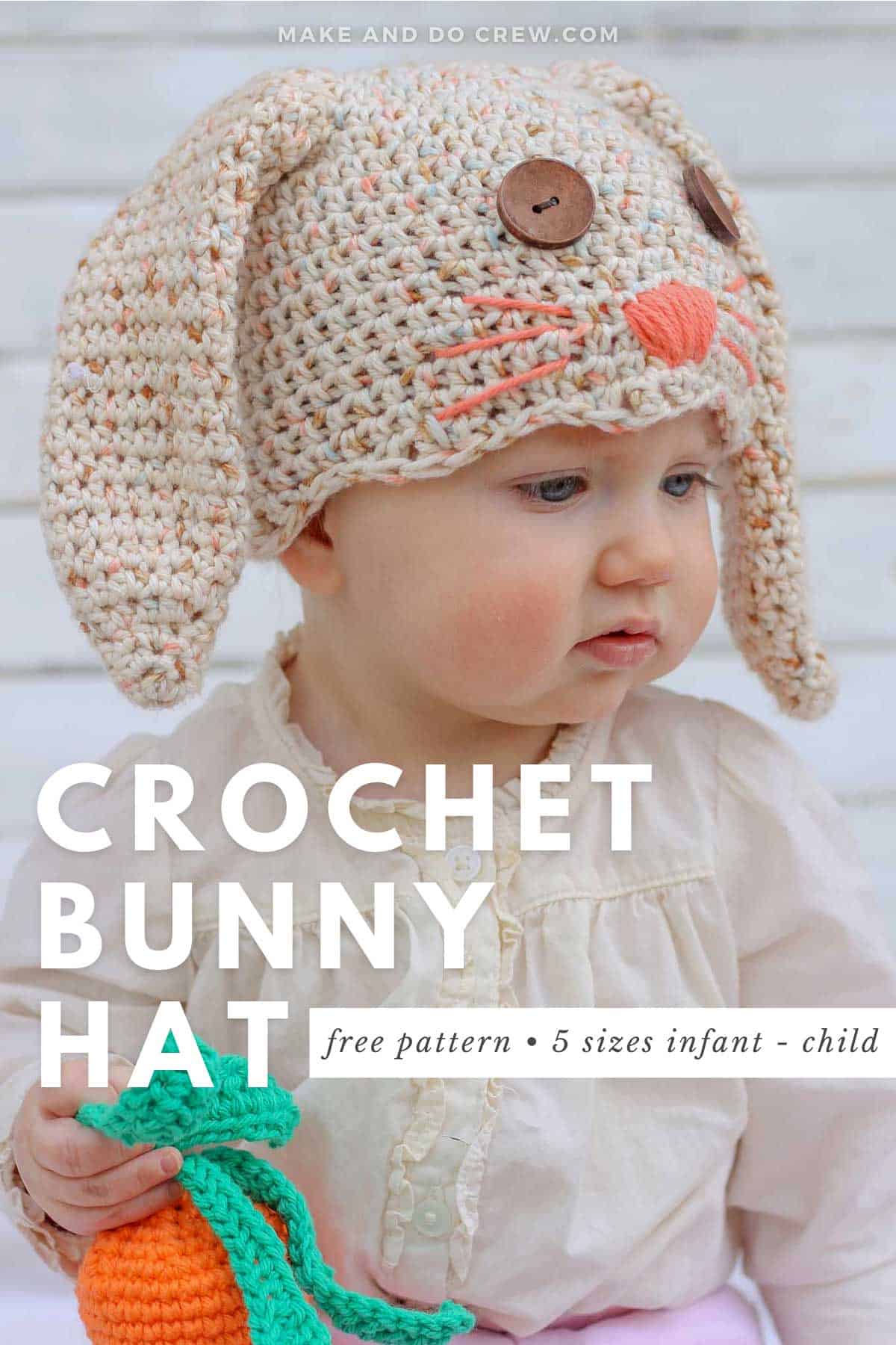 A chubby-cheeked baby wearing a crochet bunny hat complete with button eyes and sweet whiskers.