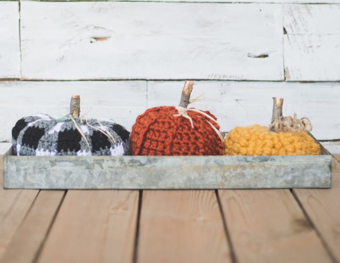 This free crochet pumpkin pattern adds a rustic and modern DIY touch to your Halloween and Thanksgiving decorations. A crochet plaid pumpkin, A crochet jute pumpkin and a chunky crochet pumpkin made with Wool Ease Thick & Quick complete this adorable trio by Meg Made with Love.