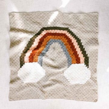 C2C crochet rainbow blanket with puff stitch clouds.