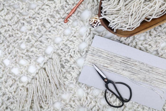 How to add fringe to a crochet or knit blanket pattern. Yarn pictured is Lion Brand Wool-Ease in "wheat."