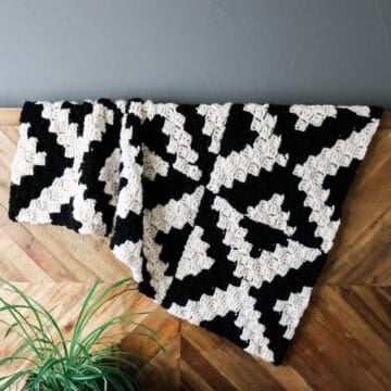 Corner to corner crochet blanket made in a graphic tile pattern.